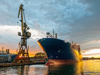 cargo ship in the harbor at sunset. gdansk, poland.